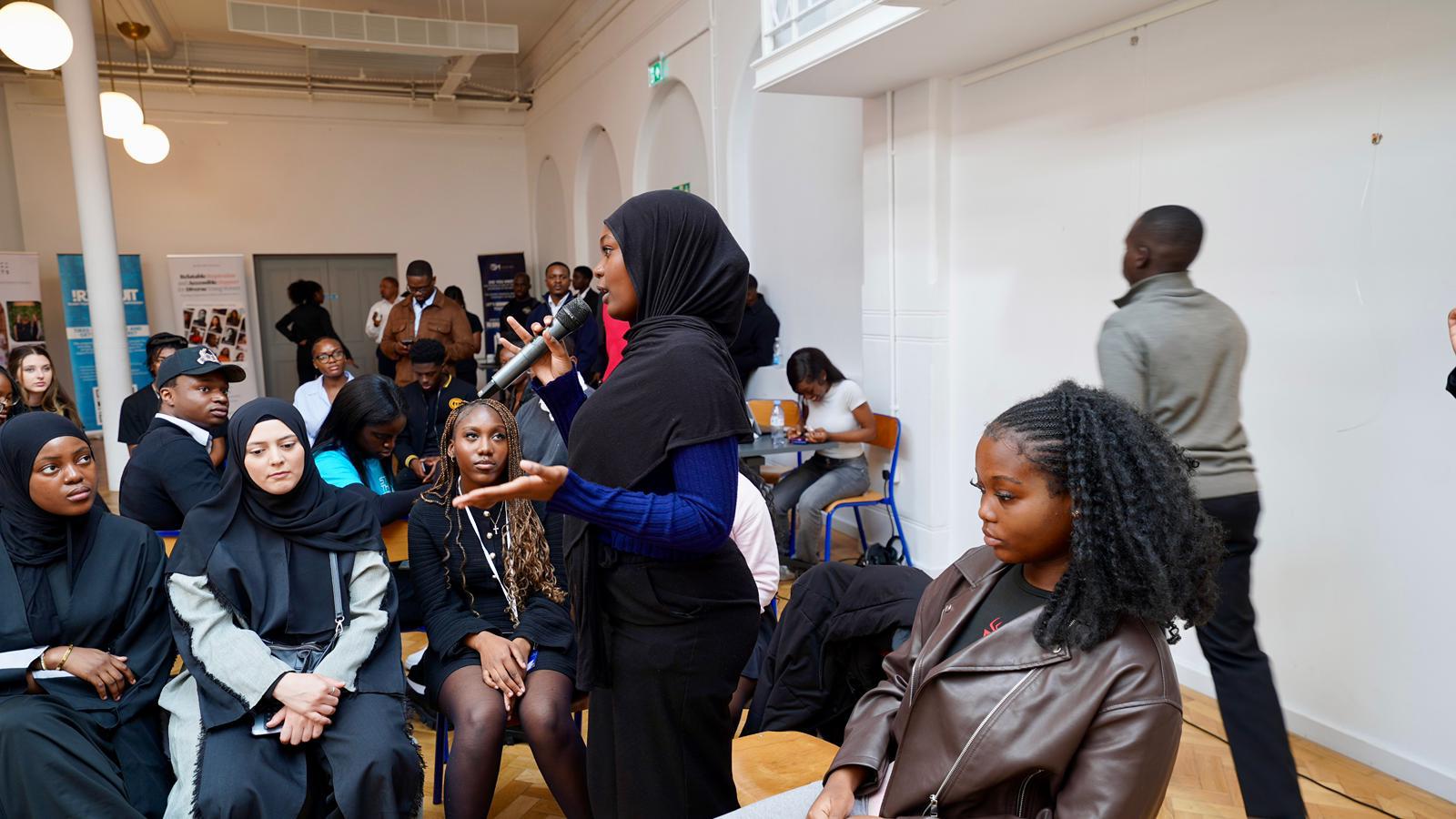 Young person asking a question during the event
